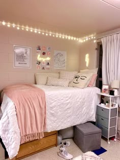 a bed room with a neatly made bed and lots of clutter on the floor