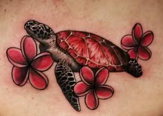 a woman's chest with a turtle and flowers on it