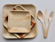 bamboo plates and utensils are arranged on a table