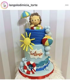 a birthday cake with an image of a boy in the top tier and beach decorations