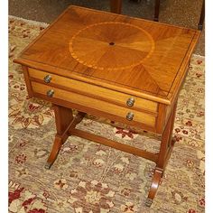 a wooden table sitting on top of a rug