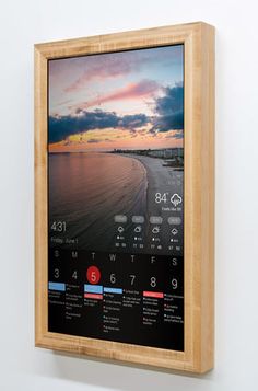 a wooden frame hanging on the wall displaying a calendar