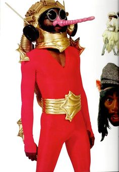 a man in a red and gold costume with his tongue sticking out to the side