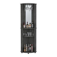 a tall wooden cabinet with liquor bottles and glasses on it's shelves, next to a mirror