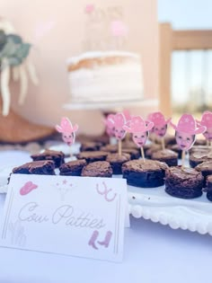 there are some cupcakes on the table with little toppers in the shape of animals