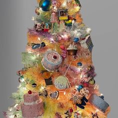 a brightly colored christmas tree decorated with ornaments