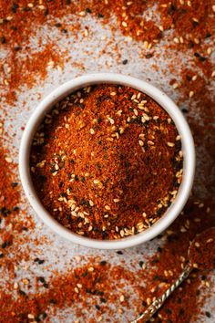 a white bowl filled with spices on top of a table