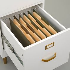 an open file cabinet with many files in it's drawer and two handles on each side