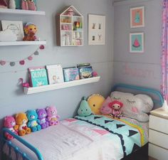 a child's bedroom with stuffed animals on the bed