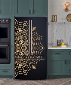 an intricately designed refrigerator in a kitchen with green cabinets and marble counter tops, along with wooden flooring