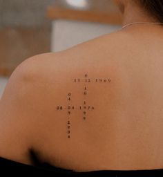 the back of a woman's shoulder with words written on it