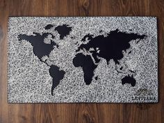 a black and white world map on a wooden floor