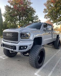 a silver truck parked in a parking lot