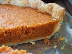 a piece of pie sitting on top of a metal pan next to an orange peel