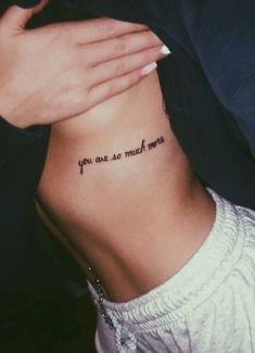 a woman with a tattoo on her stomach saying you are so much more than me