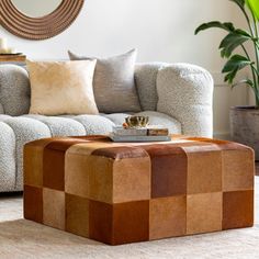 a living room with a couch, chair and coffee table in front of a mirror