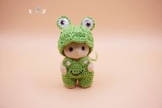 a small stuffed animal wearing a green outfit