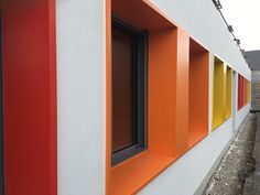 an orange and white building with multiple colored windows