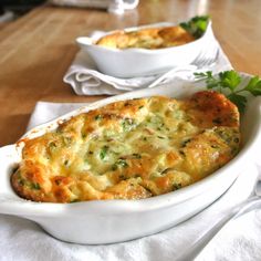 a casserole dish with broccoli and cheese in it on a table