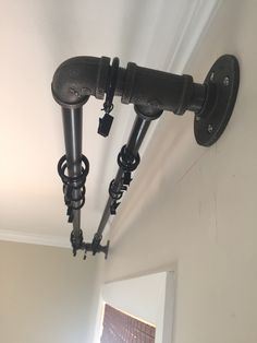 two black pipes are attached to the wall