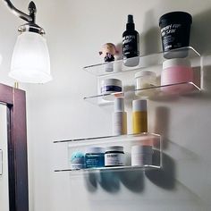 the bathroom is clean and ready to be used as a shelf for hair care products