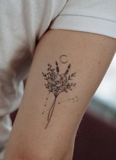 a woman's arm with a flower tattoo on the left side of her body