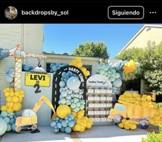 this is an image of a construction themed birthday party with balloons, decorations and signs