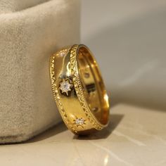 two gold wedding bands with diamonds on them