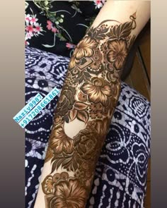 a woman's arm with henna tattoos on it