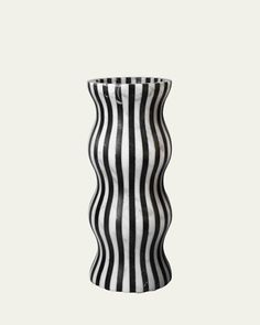 a black and white striped vase sitting on top of a table