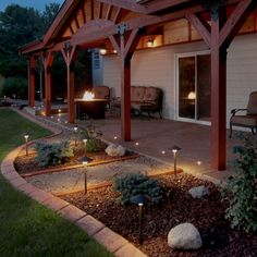 an outdoor patio with lights and landscaping