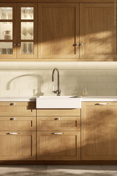 a kitchen with wooden cabinets and white counter tops, along with a sink in the center