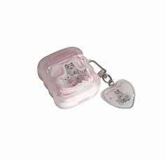 a pink case with two kittens in it and a heart shaped keychain