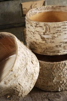 three wooden bowls sitting on top of a table