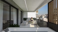 a woman sitting in a chair on top of a balcony