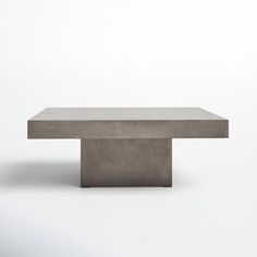 a concrete table sitting on top of a white floor