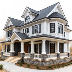 a large white house with lots of windows on it's front and side porch