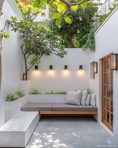 an outdoor seating area with plants and lights