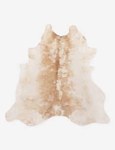 a brown and white cowhide rug on a white background