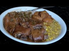 a white bowl filled with meat and corn