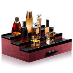 an assortment of perfume bottles on a wooden tray