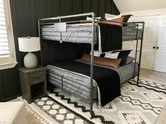 a bunk bed with two sets of mattresses on top of it in a room