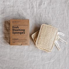 the dish washing sponges are sitting next to a cardboard box