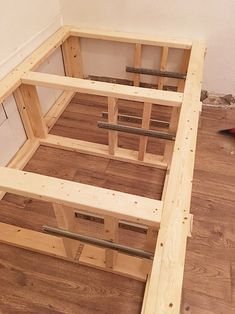 an unfinished bed frame is sitting on the floor