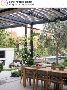 an outdoor dining area with wooden table and chairs