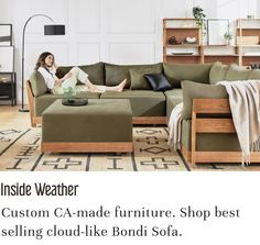 a woman sitting on top of a couch in a living room next to a coffee table