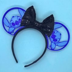 a blue and black mickey mouse ears with an image of stitching on the ears