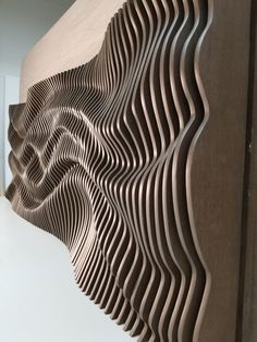 an abstract wooden sculpture is shown in this photo