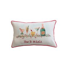 a white pillow with red trim that says how toallaa and two champagne glasses on it