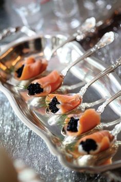 a silver tray topped with lots of food on top of a table